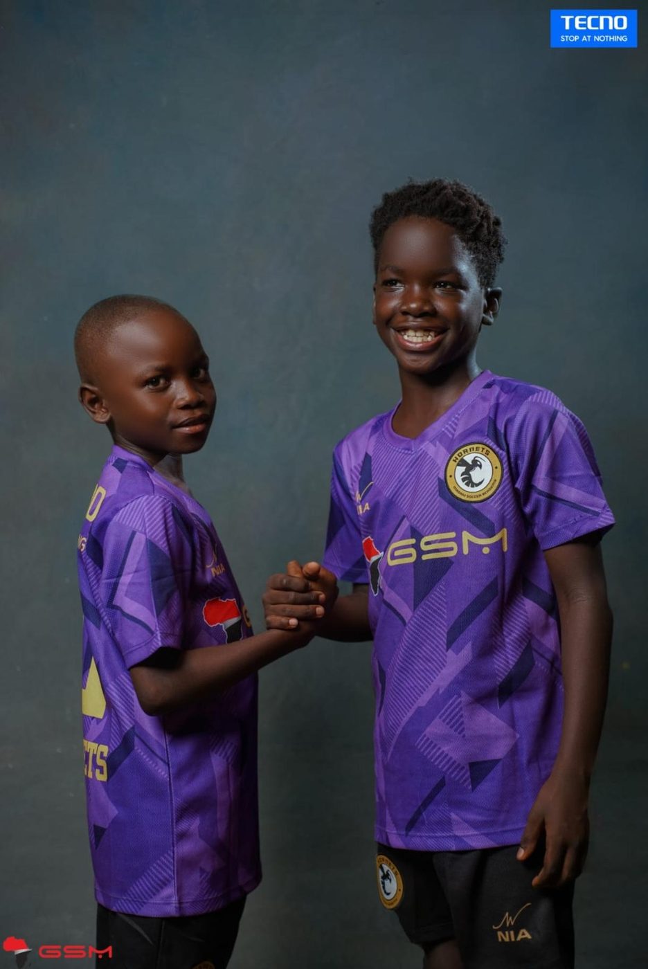 Two Hornets Soccer Academy players greeting each other in custom NIA kits