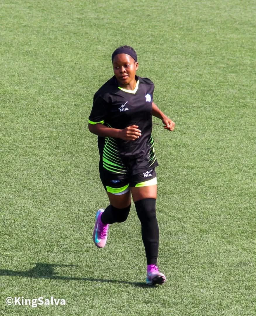 Ceasiaa Queens FC player in a custom NIA match kit, in action