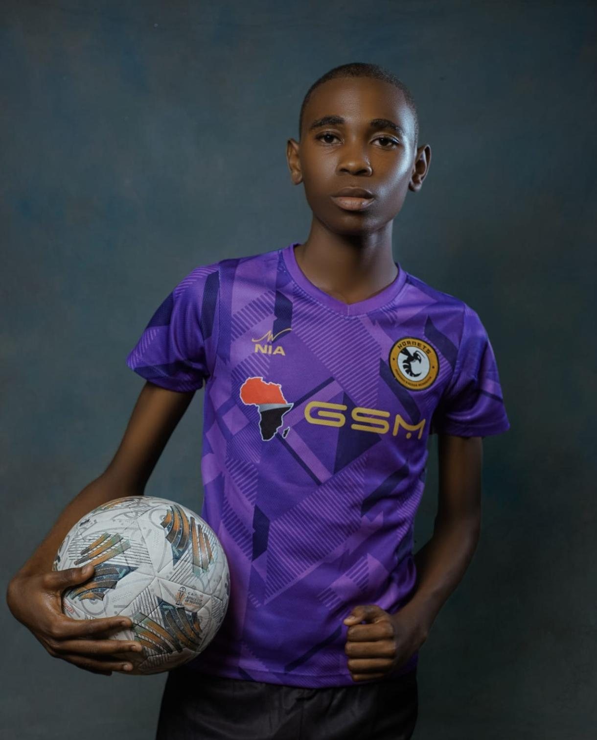 Two Hornets Masaki Football Academy players in custom NIA kits